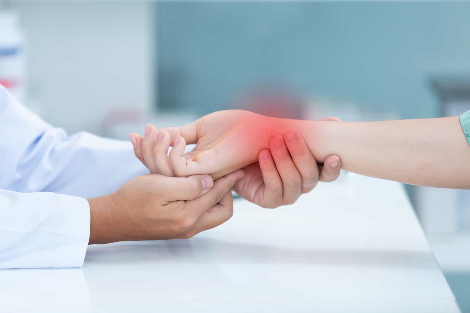 Rheumatologist in Dallas, TX 3 Doctor examining patient's painful wrist