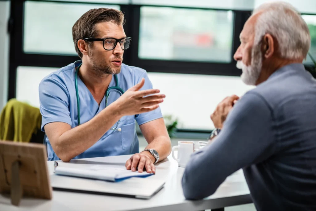 Doctor in discussion with an older male patient during a consultation.