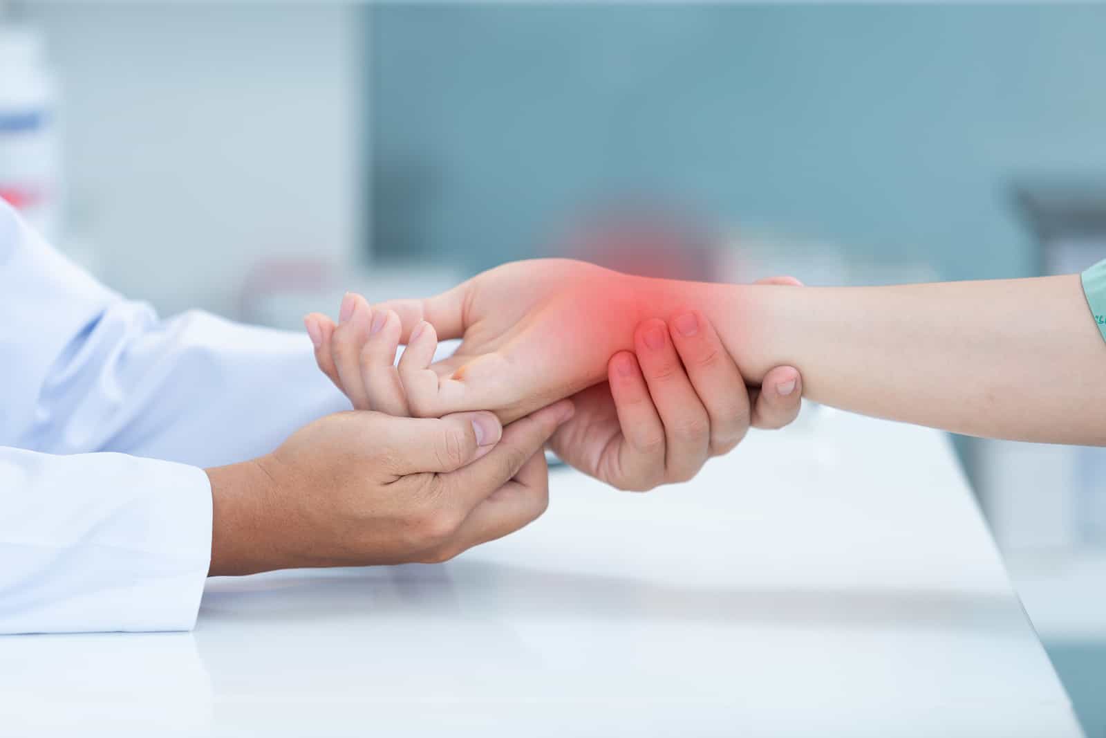 Doctor examining patient's painful wrist