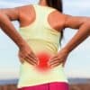 Woman with back pain holding her lower back