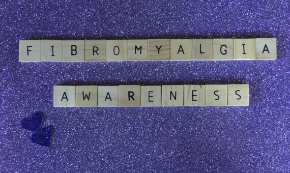 Scrabble tiles spelling out "fibromyalgia awareness"