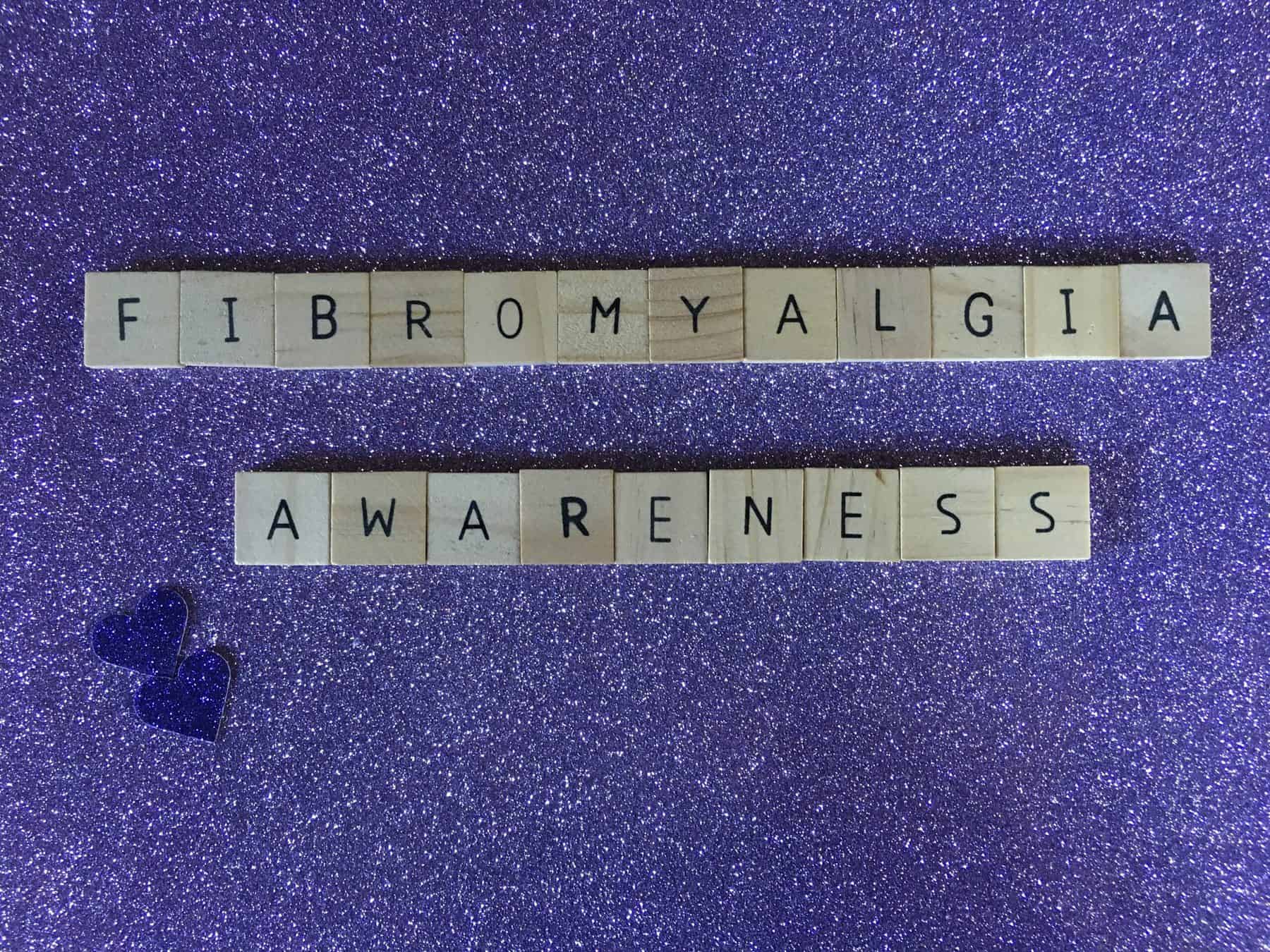 Scrabble tiles spelling out "fibromyalgia awareness"