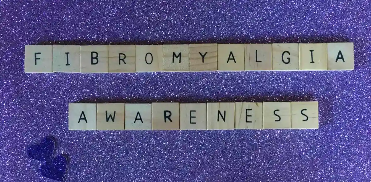 Scrabble tiles spelling out "fibromyalgia awareness"