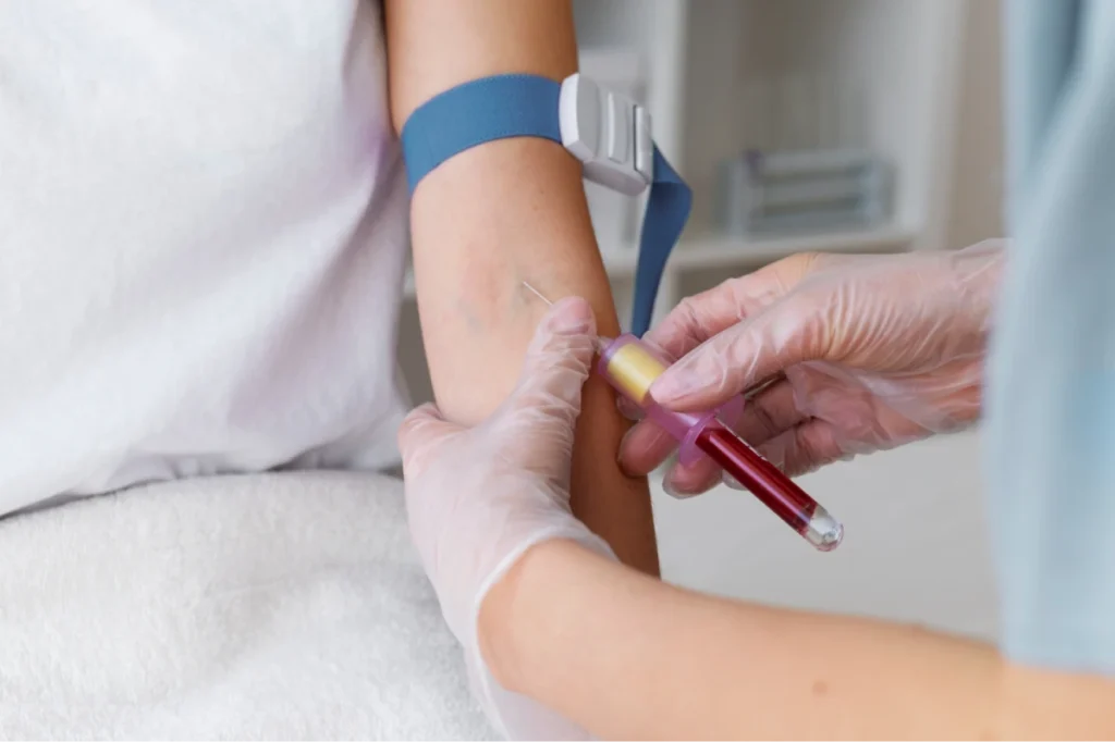 Nurse drawing blood from a patient's arm.