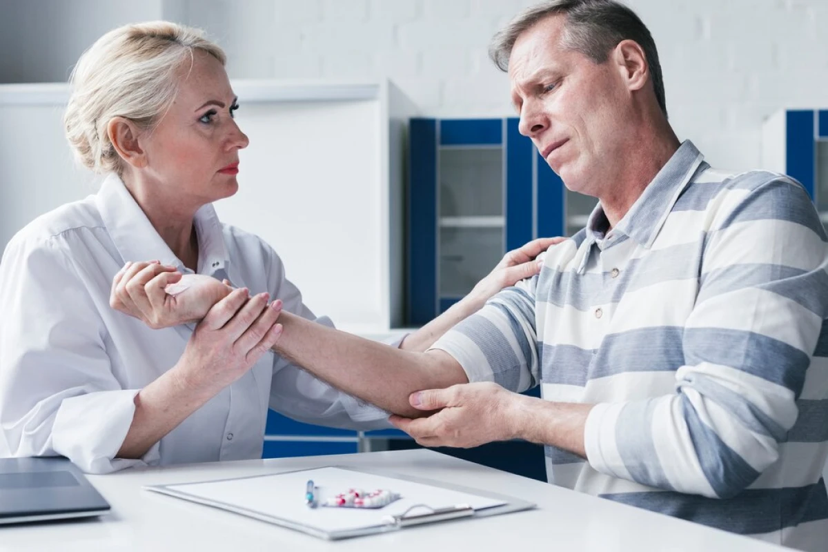A doctor performing an examination on a patient’s arm.