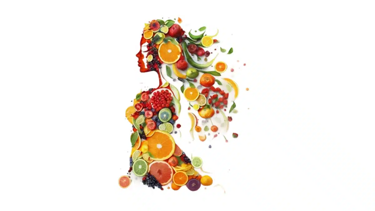 A woman's silhouette made of colorful fruits and slices.