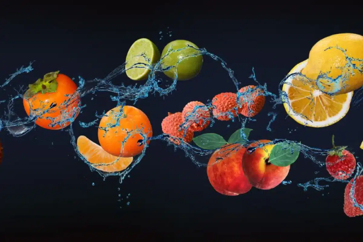 Fruits with splashing water on a dark background.